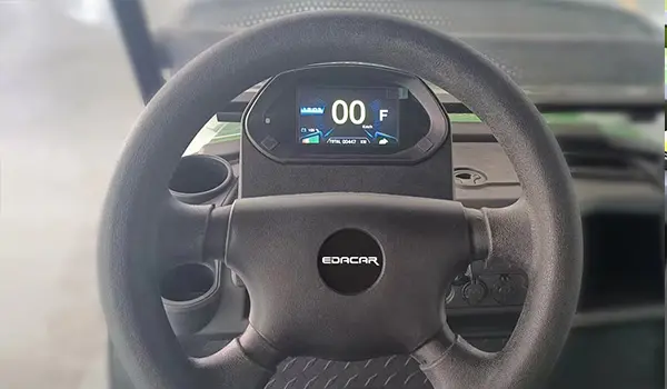 Multi-function display gauge showing speed and temperature readings on a vehicle dashboard.