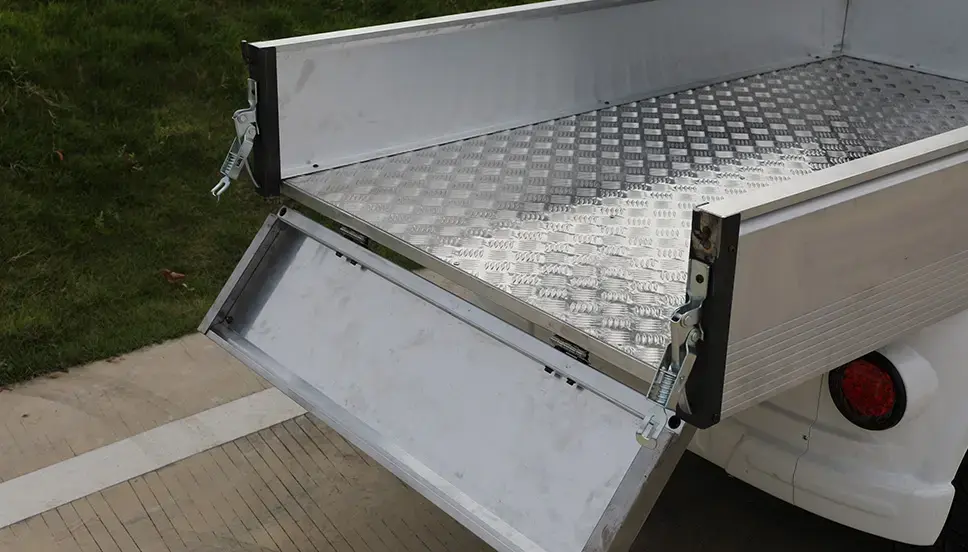 Utility E-Cart Cargo Bed with Drop-Down Tailgate for Easy Loading. Close-up of the rear of a utility e-cart