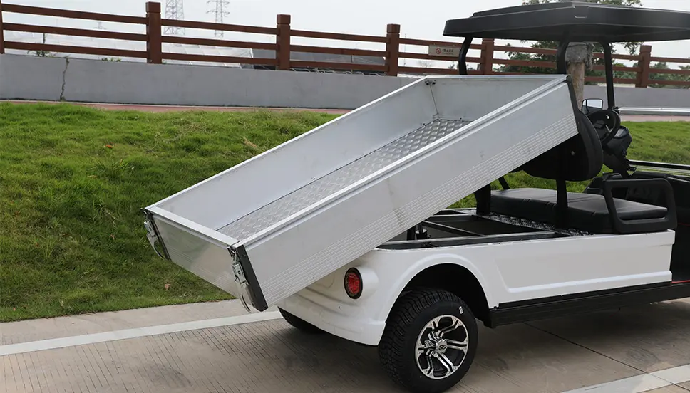 Utility E-Cart with Tilt Bed for Convenient Hauling and Loading. Utility e-cart with the cargo bed tilted for easy loading and unloading.