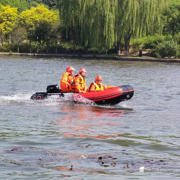Inflatable Boat in Action on the Lake Four individuals wearing orange safety gear riding in a red inflatable boat on a lake.
